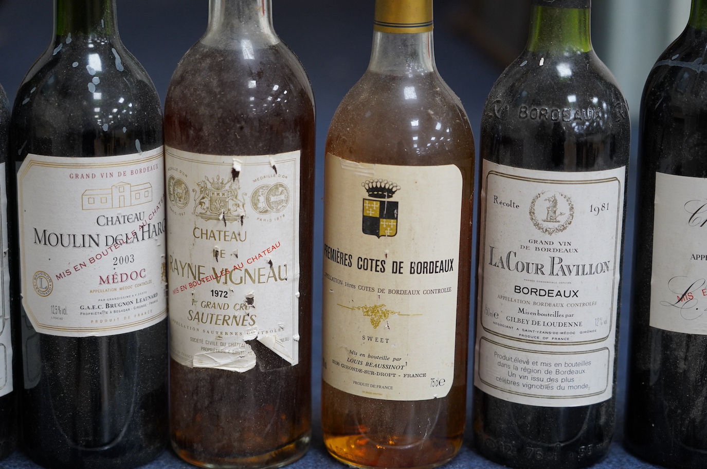 Eleven bottles of wine: Chateau Moulin Hargue 2003 x1, Chateaux Cissac 1982x2, Chateau la Coer Pavillion 1981 x2, Chateaux de barbe 1976 x1, Chateaux Haut Batailly 1998 x1, Premier Cotes de Bordeaux NV x1, Domain de Mart